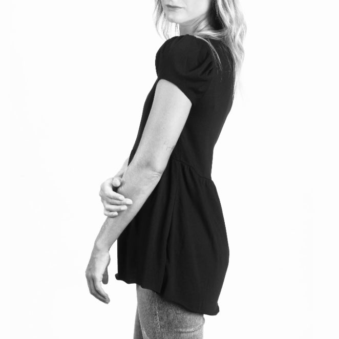 black cotton modal cap sleeve babydoll tee side view on model